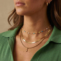 Thumbnail for Rainbow Choker featuring colorful enamel beads on a gold chain, styled with layered necklaces by Brother & Sisters.