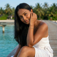 Thumbnail for Young woman wearing a Paperclip Chain Bracelet, showcasing its elegant design by Brother & Sisters.