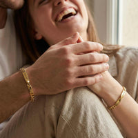 Thumbnail for Couple wearing Infinity Bond Matching Bracelets by Brother & Sisters, symbolizing unbreakable connection.