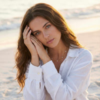 Thumbnail for Dainty Pearl Choker worn by model on the beach, featuring tiny freshwater pearls on a delicate gold chain by Brother & Sisters.