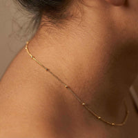 Thumbnail for Julia Beaded Chain Necklace worn elegantly, featuring tiny golden beads for an understated look by Brother & Sisters.