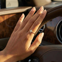 Thumbnail for Hand wearing a Crystal Flower Ring by Brother & Sisters, featuring a delicate four-leaf crystal flower design.