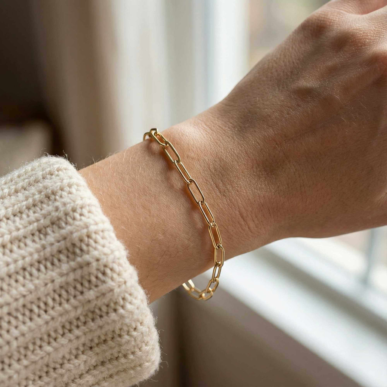 Paperclip Chain Bracelet on wrist, showcasing elegant links in 18K gold by Brother & Sisters.
