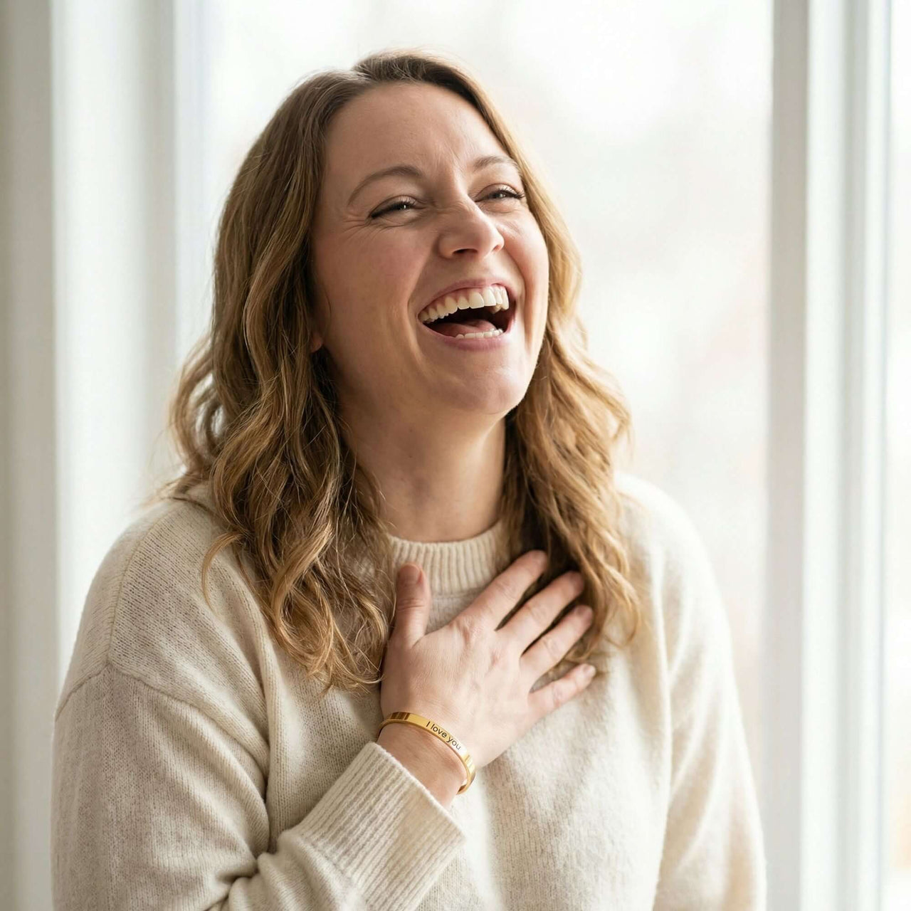 Laughing woman wearing a Matching Couple Bracelet by Brother & Sisters, showcasing personalized engravings.