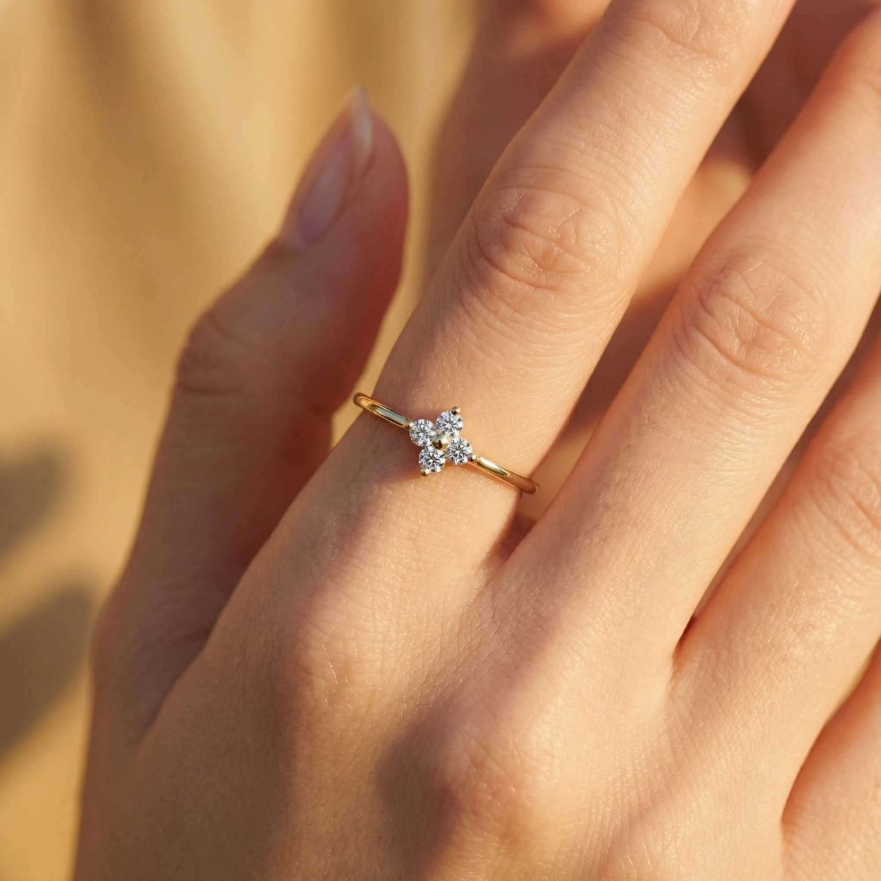 Crystal Flower Ring on a delicate hand featuring a four-leaf zirconia flower, by Brother & Sisters.