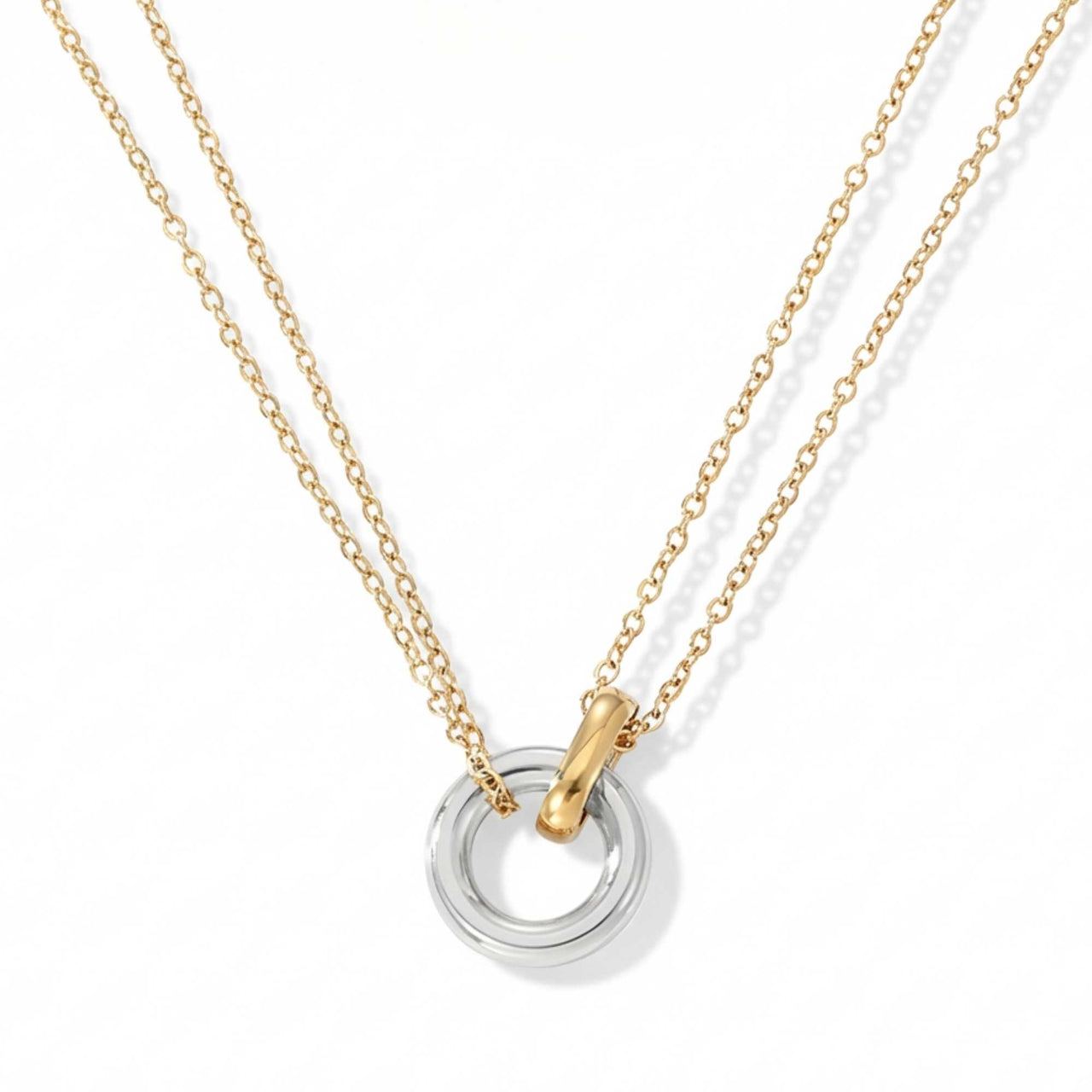 The Unity Bond necklace by Brother & Sisters features a silver circle and gold bar pendant.