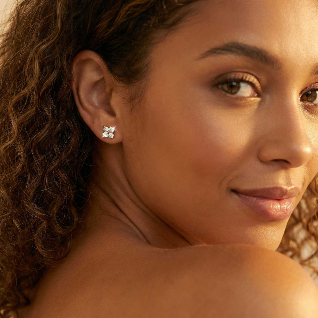 Crystal Flower Stud Earrings worn by a model, showcasing tiny four-leaf flowers with zirconia stones from Brother & Sisters.