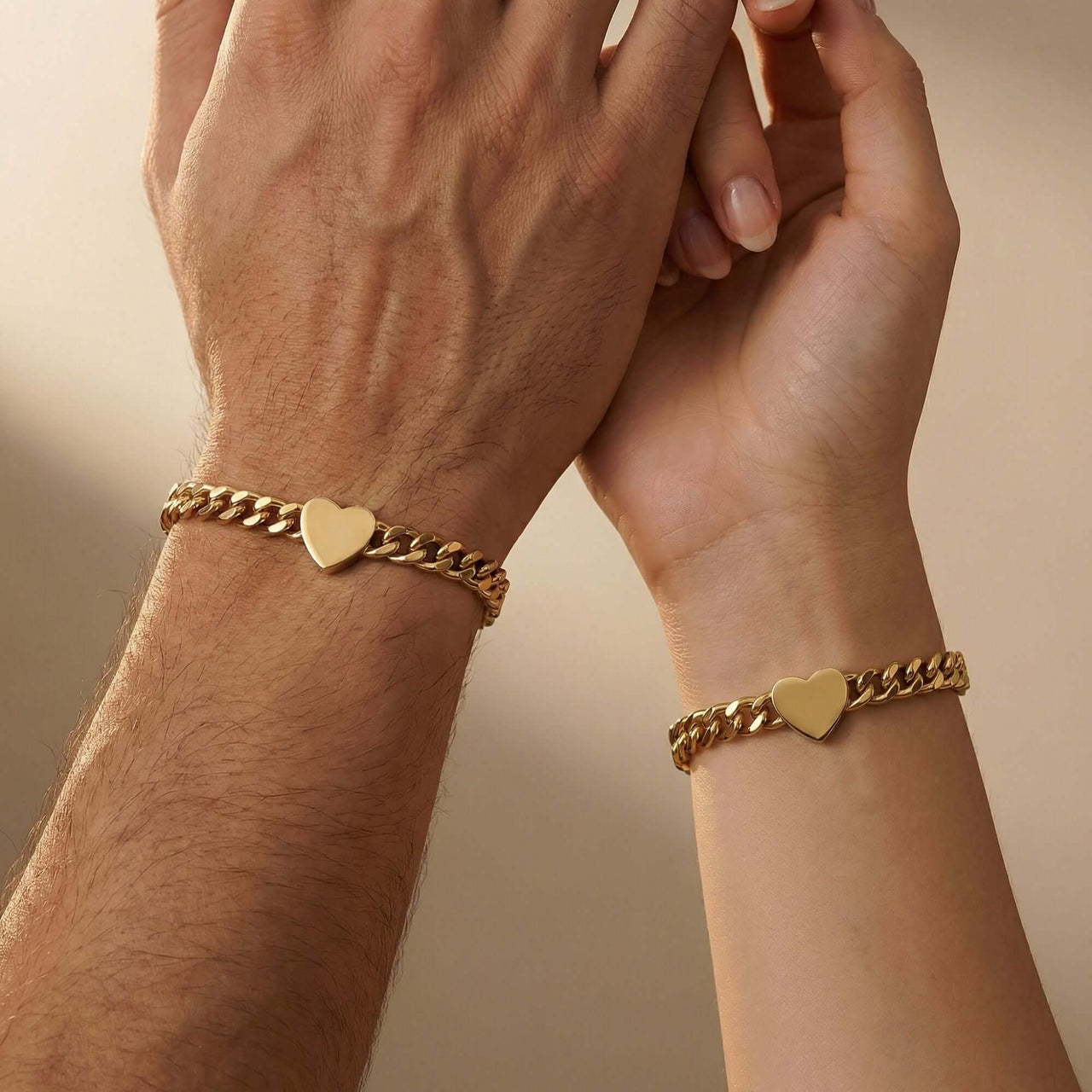 Love Couple Bracelet featuring matching gold Cuban link chains with heart pendants by Brother & Sisters.
