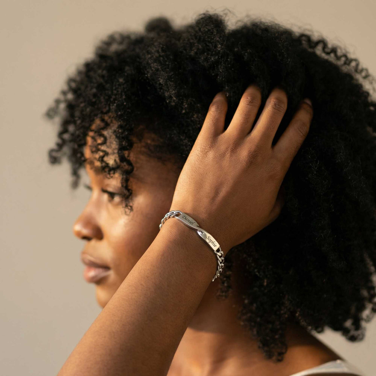 Infinity Bond Matching Bracelet worn by a woman, showcasing its twisted bar design by Brother & Sisters.