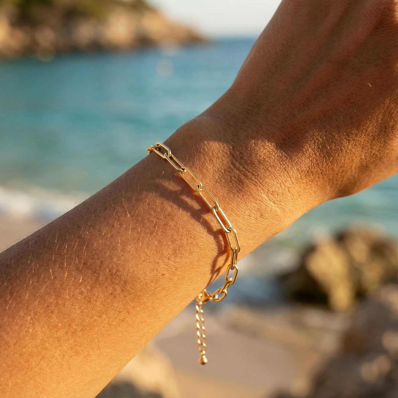 Paperclip Chain Bracelet by Brother & Sisters on a wrist with clean links near the beach, showcasing its stylish elegance.