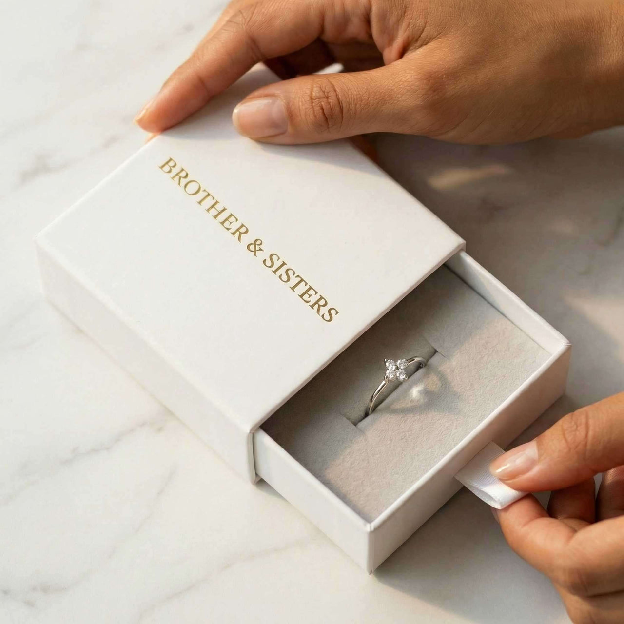 Crystal Flower Ring in a Brother & Sisters gift box, showcasing its delicate design and sparkle.