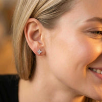Thumbnail for Crystal Flower Stud Earrings worn by a woman, showcasing tiny flower design and sparkling zirconia stones by Brother & Sisters.