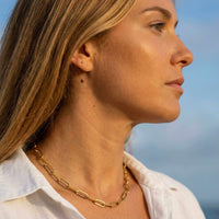 Thumbnail for Model showcasing Ria Paperclip Chain Necklace by Brother & Sisters, featuring bold oversized links in 18K gold PVD.
