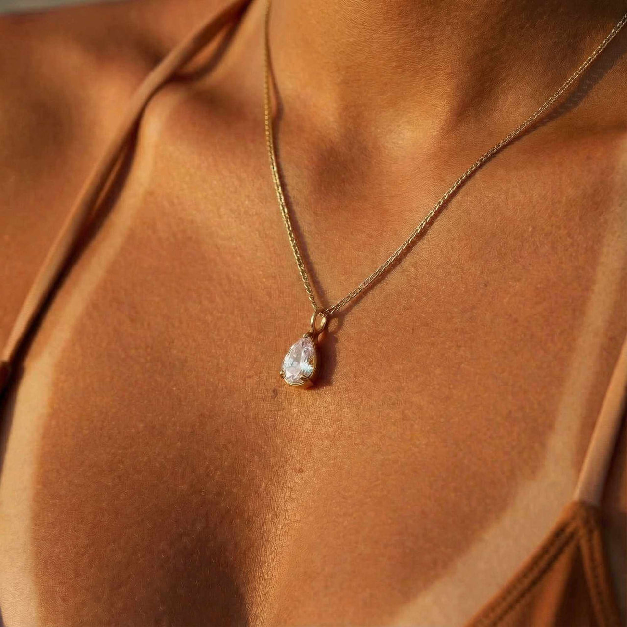 Astra Teardrop Necklace by Brother & Sisters featuring a shimmering teardrop-cut white stone on a delicate chain.