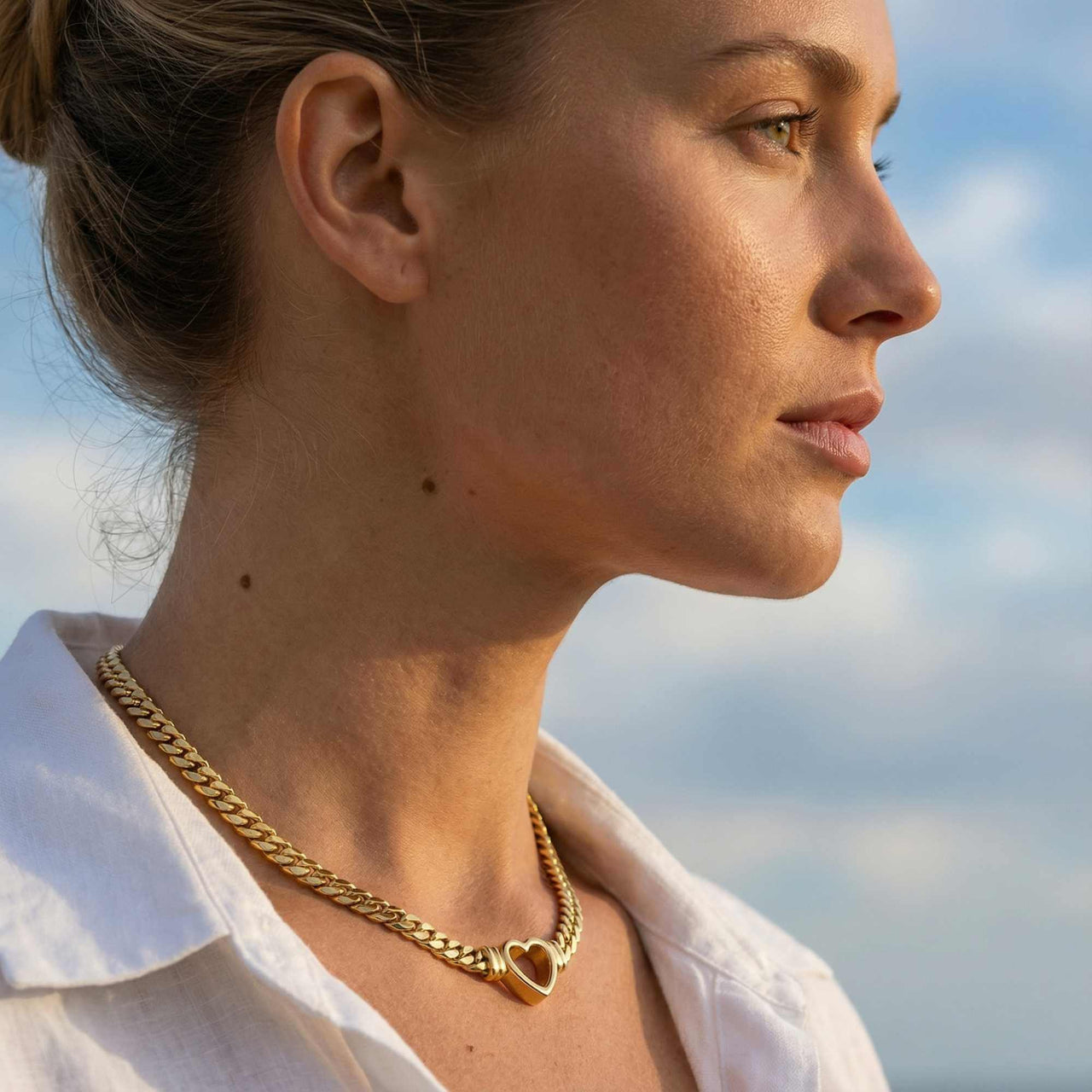 Vali Heart Choker Necklace worn by a woman featuring a chunky Cuban chain and delicate heart, by Brother & Sisters.