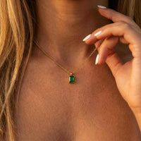 Thumbnail for Emerald Pendant Necklace in gold setting worn by a woman, featuring vibrant emerald green stone by Brother & Sisters.