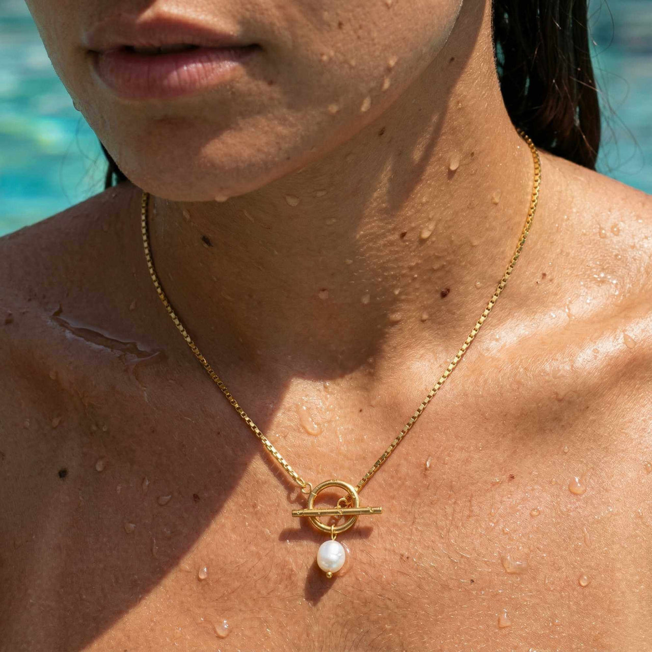 La Isla Pearl Toggle Necklace featuring a sculptural gold T-bar clasp and freshwater pearl by Brother & Sisters.