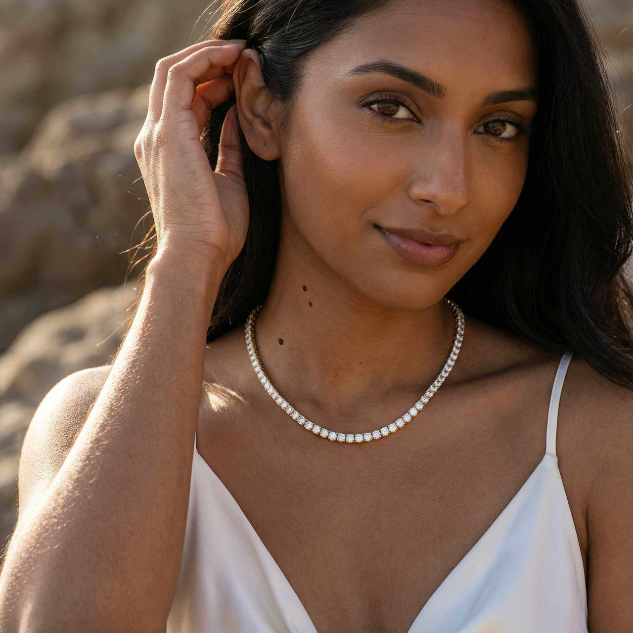 Isolde Tennis Necklace worn by a woman, featuring brilliant-cut diamond simulants set in 18K gold by Brother & Sisters.