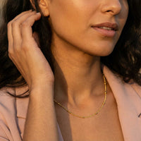 Thumbnail for Model wearing Julia Beaded Chain Necklace by Brother & Sisters, showcasing the delicate golden beads and elegant design.