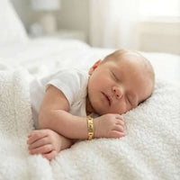 Thumbnail for Infant Bracelet on sleeping baby by Brother & Sisters, showcasing personalized charm and elegance.