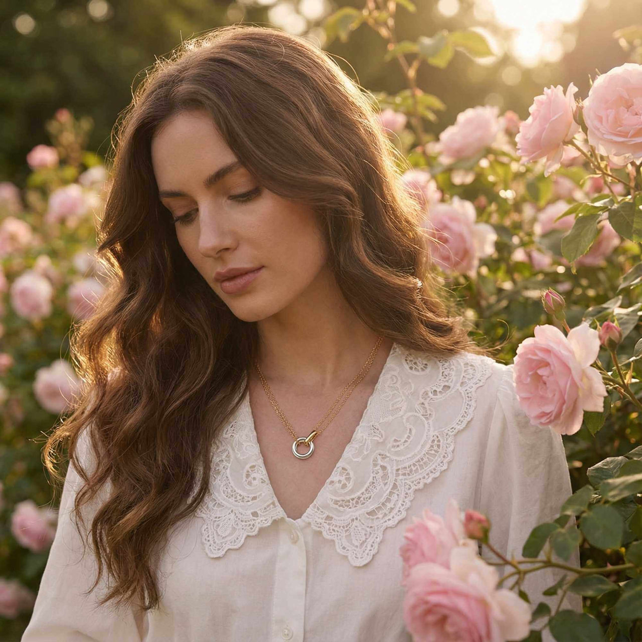 The Unity Bond necklace by Brother & Sisters featuring polished silver and gold, worn by a model in a rose garden.
