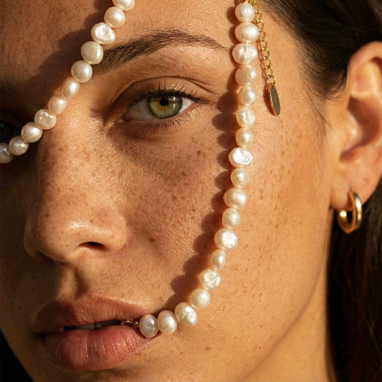 Sunseeker Pearl Choker showcasing unique baroque pearls on a golden chain by Brother & Sisters.
