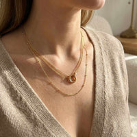 Thumbnail for The Eternal Link necklace by Brother & Sisters features delicate gold chains and an interlocking circle pendant.