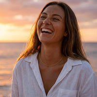 Thumbnail for Woman smiling by the ocean wearing a Rope Chain Necklace, enjoying sunset, showcasing effortless style from Brother & Sisters.