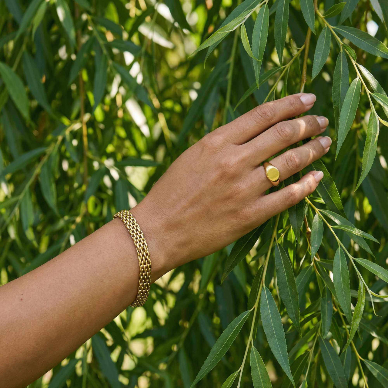 Sifnos Woven Bracelet worn on a hand, showcasing intricate gold design, by Brother & Sisters.