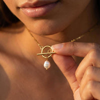 Thumbnail for La Isla Pearl Toggle Necklace featuring a gold T-bar clasp and a freshwater pearl by Brother & Sisters.