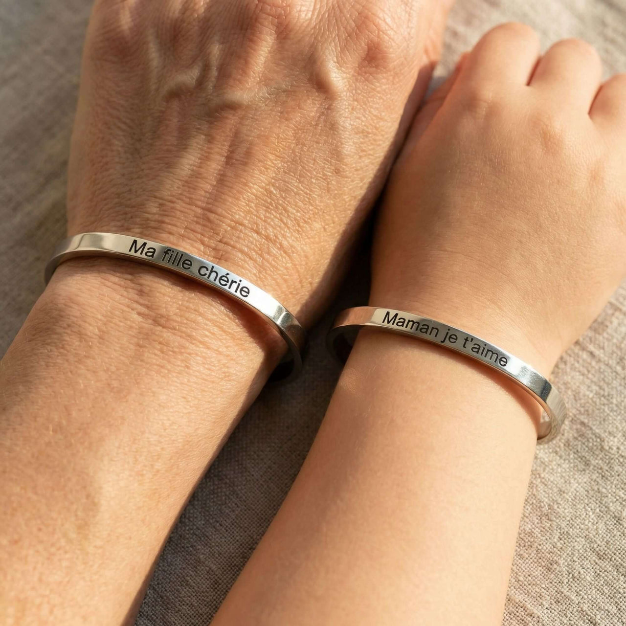 Matching Couple Bracelet by Brother & Sisters showcasing engraved names on matching minimalist cuffs.