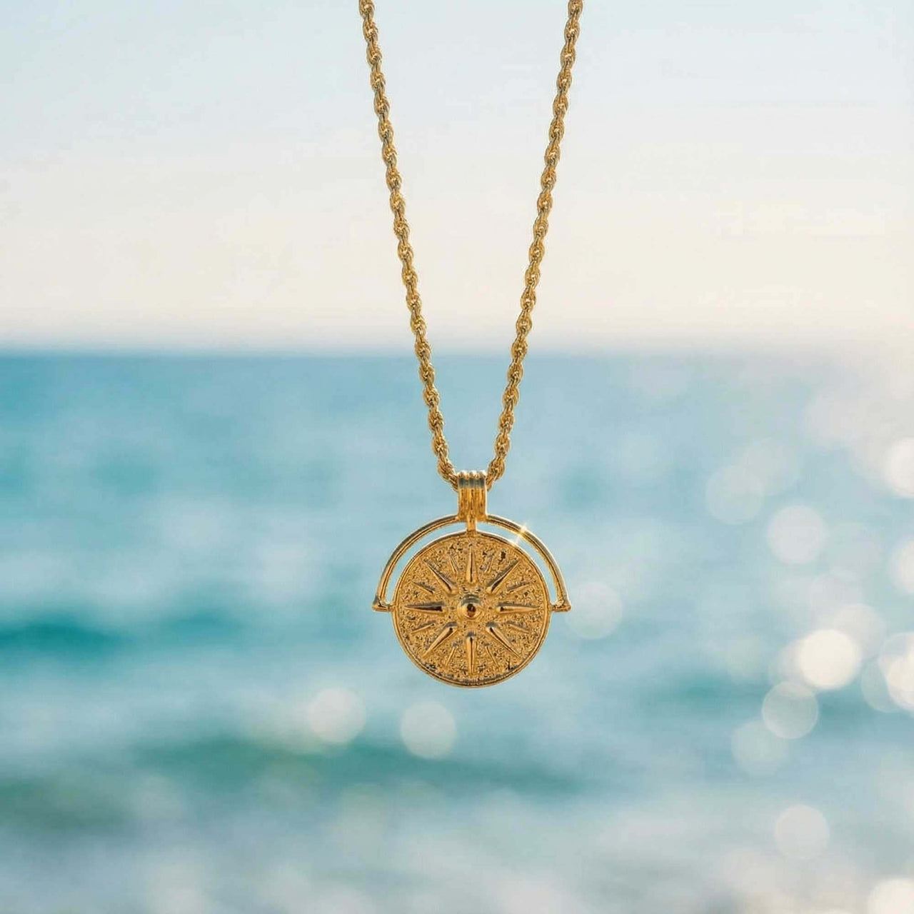 Golden Sun Necklace by Brother & Sisters features a sun medallion on a rope chain, symbolizing positivity and vitality.