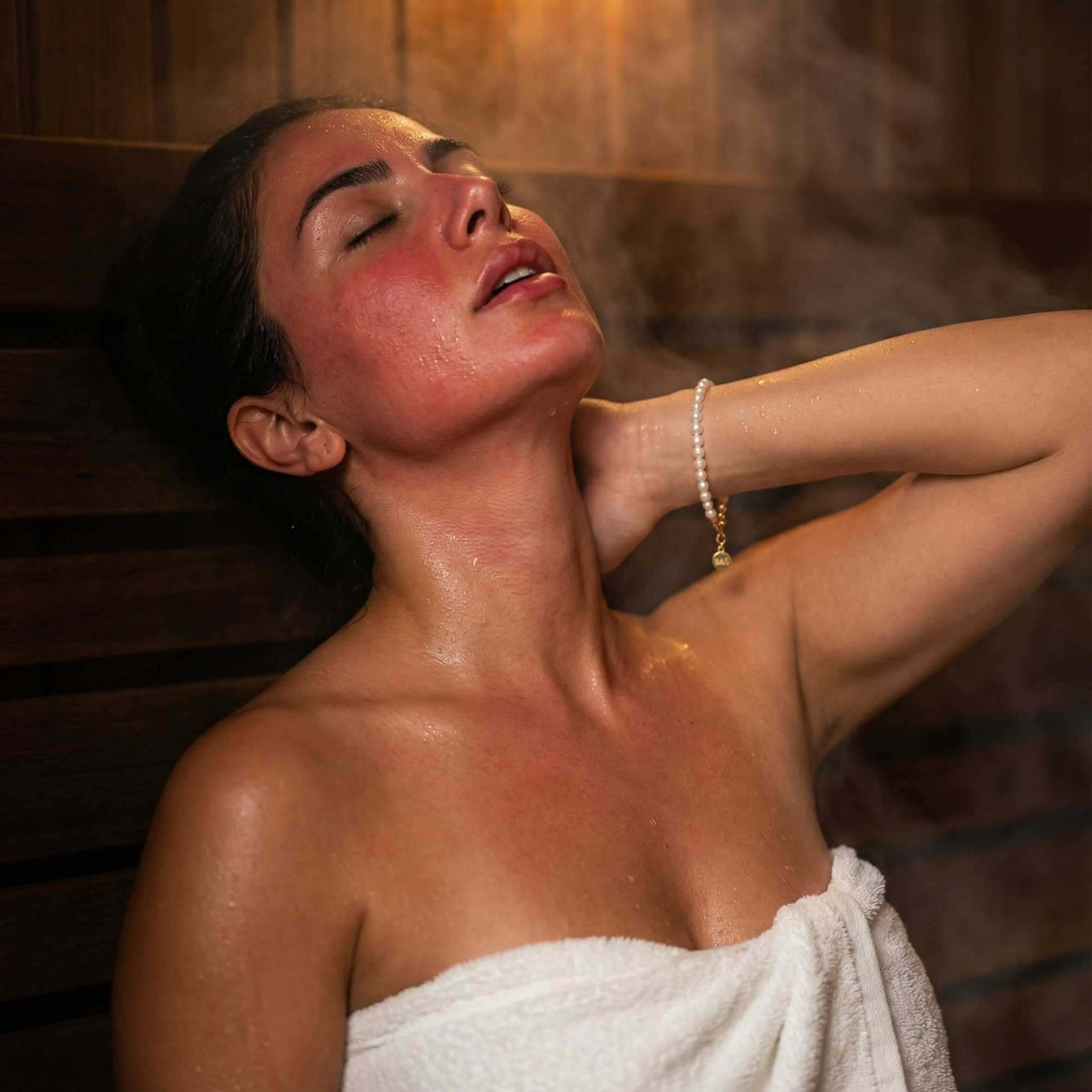 Woman enjoying a steam bath wearing a Freshwater Pearl Bracelet by Brother & Sisters, showcasing unique pearls.