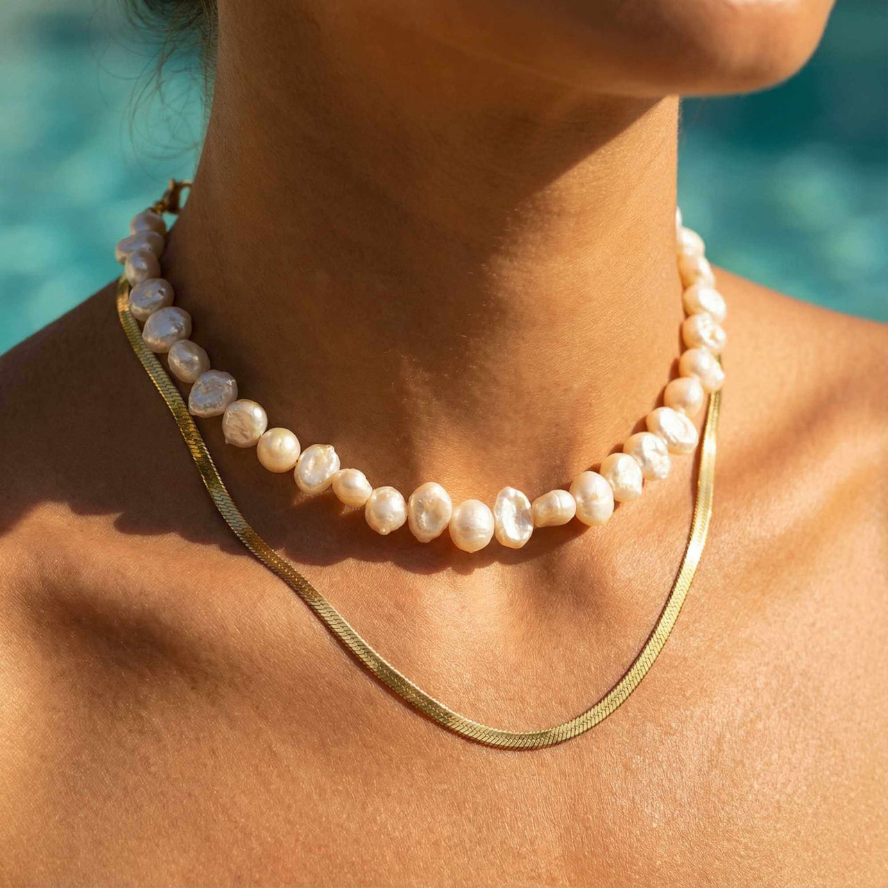 Sunseeker Pearl Choker featuring unique baroque pearls with organic shapes on a golden chain by Brother & Sisters.