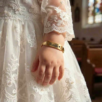 Thumbnail for Infant Bracelet worn by child in elegant dress, featuring personalized name 'Matilda' by Brother & Sisters.