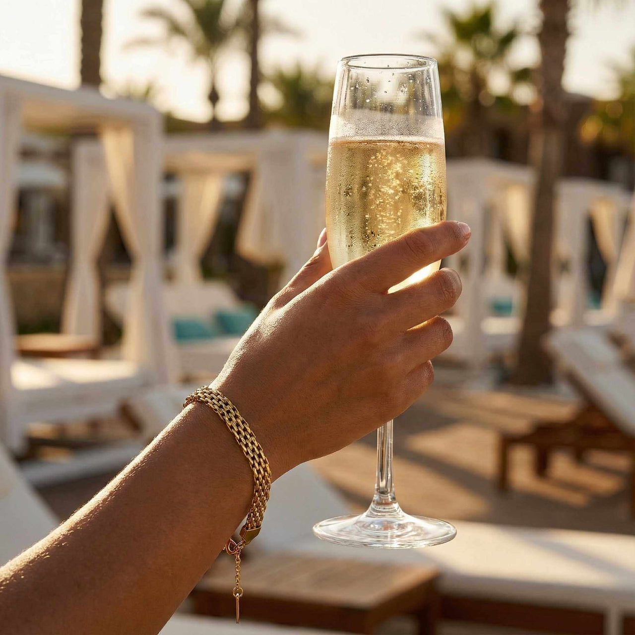 Sifnos Woven Bracelet worn while holding a champagne glass by Brother & Sisters, perfect for elegant occasions.
