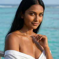 Thumbnail for Model wearing Julia Beaded Chain Necklace by Brother & Sisters against a tropical background.