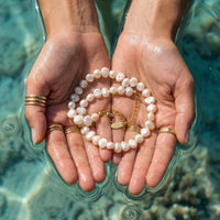 Thumbnail for Sunseeker Pearl Choker by Brother & Sisters showcasing irregular baroque pearls on a golden chain in hands.