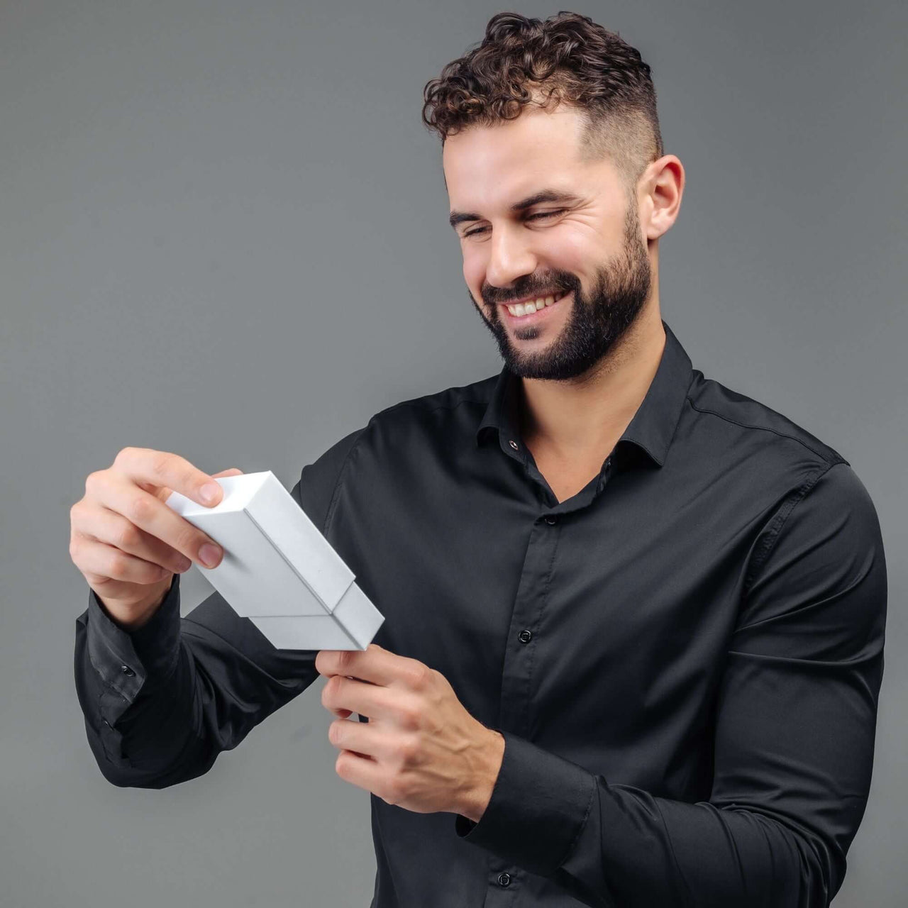 Man Grey Photo Bracelet being unwrapped by a smiling man in a black shirt, perfect gift by Brother & Sisters.