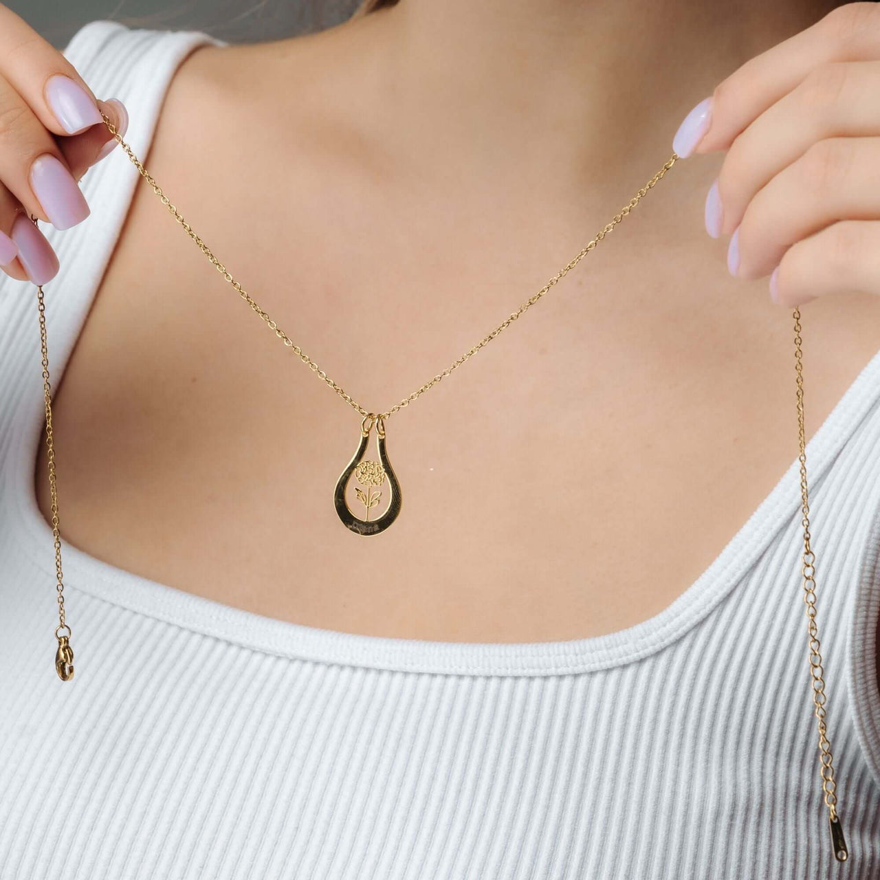 Birth Flower Name Necklace featuring a gold teardrop pendant worn by a model showcasing personalized elegance by Brother & Sisters.