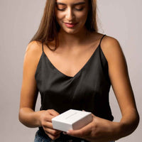 Thumbnail for Woman unboxing a Love Photo Necklace from Brother & Sisters, showcasing a personalized keepsake.