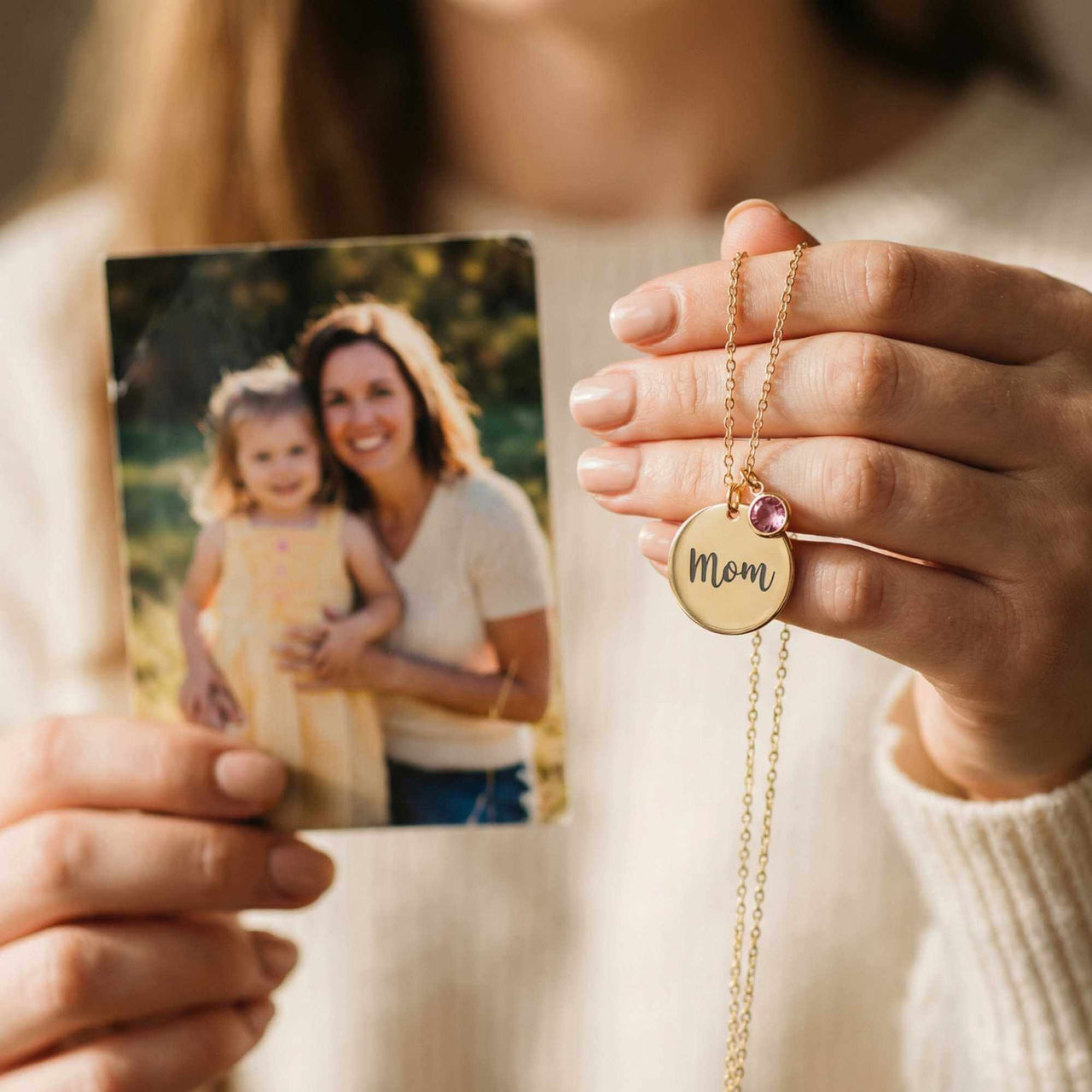 Precious Name Necklace held by a person showing a photo, featuring a personalized 'Mom' pendant with a birthstone, by Brother & Sisters.
