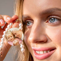 Thumbnail for Beaded Photo Bracelet by Brother & Sisters featuring a woman holding a personalized photo charm of a cherished memory.