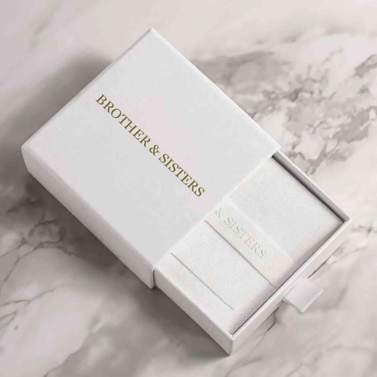 Sun Photo Necklace packaging by Brother & Sisters, elegant white box with gold lettering, perfect for gift-giving.