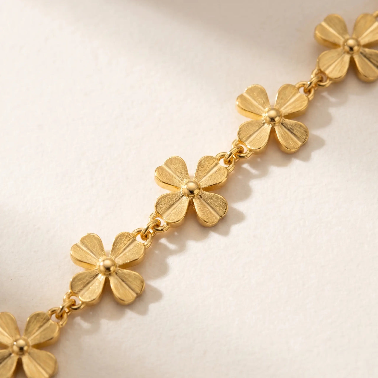 Daisy Charm Anklet featuring 18K gold plated stainless steel and continuous chain of small 4-petal daisies by Brother & Sisters.