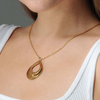 Thumbnail for Drop Name Necklace by Brother & Sisters featuring a gold drop-shaped design with personalized names.