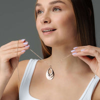 Thumbnail for Model showcases the elegant Drop Name Necklace by Brother & Sisters, highlighting its sleek drop-shaped design.