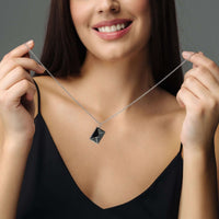 Thumbnail for Model showcasing the Envelope Name Necklace by Brother & Sisters, personalized silver jewelry with elegant design.