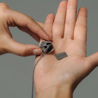 Thumbnail for Envelope Name Necklace by Brother & Sisters showcasing a personalized pendant held in a hand.