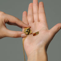 Thumbnail for Person holding the Envelope Name Necklace components, showcasing its elegant design by Brother & Sisters.